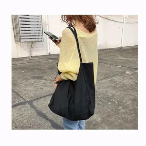 Minimalist black canvas tote bag, large capacity casual shoulder bag for women daily use.