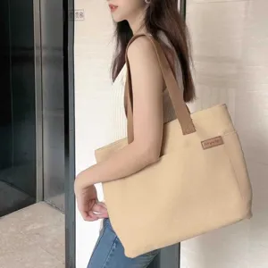Casual beige canvas tote bag for women, large capacity shoulder bag for commuting and daily use.