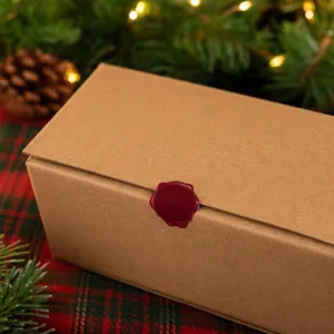 Brown cardboard gift box with retro red wax seal sticker, perfect for Christmas holiday packaging.