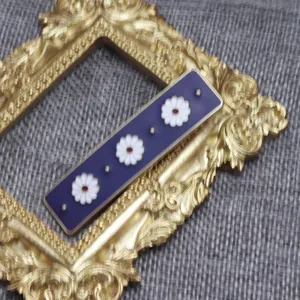 Vintage enamel daisy hair clip detail, purple rectangular barrette with white floral charms for women.