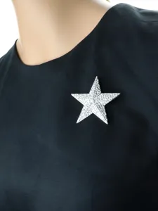 Detailed shot of a dazzling star brooch studded with sparkling rhinestones, perfect for suits.