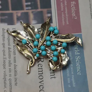 Vintage gold tone leaf turquoise bead rhinestone brooch classic botanical costume jewelry.