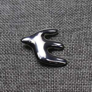 Silver metal swallow brooch detail shot, elegant clothing accessory for daily wear style.