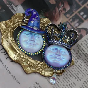 Vintage iridescent moon face brooch pendant detail, rhinestone crown and hat design.