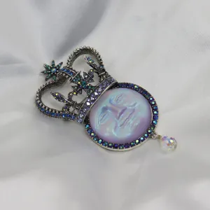 Vintage antique silver rhinestone moon face crown brooch pendant with iridescent crystal drop.