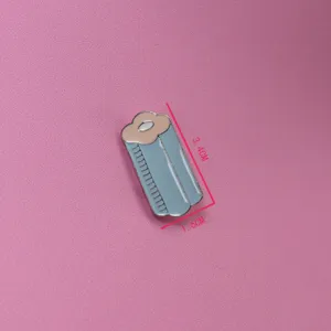 Detailed view of the cute enamel brooch, compact size with enamel glazing, blue and pink design.