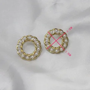 Detailed close-up view of vintage gold-plated chain round pearl earrings with dimension.