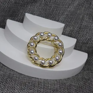 Close up detail of vintage hollow chain circular pearl brooch with elegant pearls.