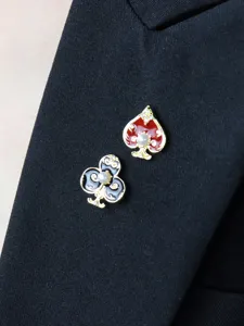 Exquisite asymmetric playing card suit brooch pin featuring pearls and vibrant enamel details.