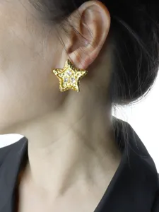 Detailed close-up shot of the vintage lava-textured star rhinestone stud earring worn on ear.