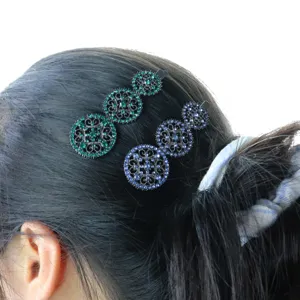 Crystal filigree round hair clip detail shot showing sparkling rhinestone bobby pins in hair.