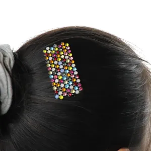 Detailed shot of a colorful rhinestone hair clip, sparkling crystal side clip for women hairstyles.