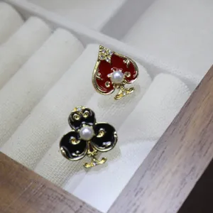 Asymmetrical poker suit brooch pin featuring red spade and black club with pearls for women.