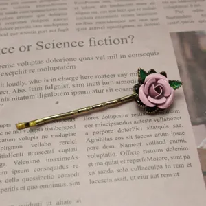 Vintage handmade enamel painted pink rose hairpin detail, classic side clip hair accessory.