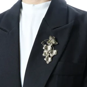 Vintage style grape leaf brooch detail shot, elegant metal plant accessory for clothing decor.