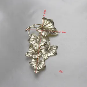 Vintage gold leaf brooch detail shot, elegant metal texture and clear veins design.
