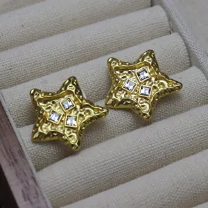 Vintage molten gold star earrings with sparkling square crystals, retro statement jewelry accessory.