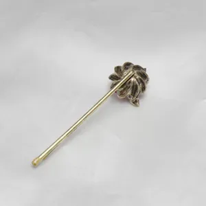 Vintage retro flower hairpin detailed close-up view showing unique metallic craft texture.