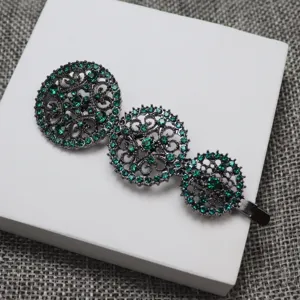 Vintage green rhinestone hair clip with triple hollow round carved metal design for elegant women.