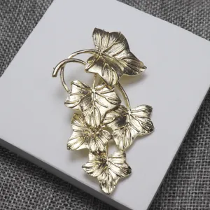 Vintage replica gold leaf brooch detailed close-up, elegant clothing accessory for gifts.
