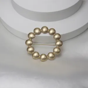 Elegant gold-toned beaded circle brooch and scarf buckle featuring a classic tambourine motif.