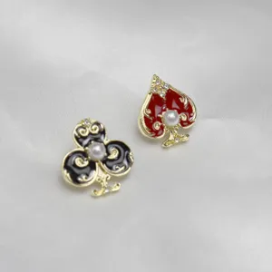 Asymmetric playing card suit brooch pin set with red heart and black club, pearl and rhinestones.