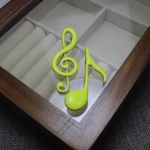 Neon green enamel music note brooch set, treble clef and eighth note lapel pin accessory.