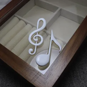 Enamel music note brooch detail, white treble clef and eighth note pin for apparel decor.