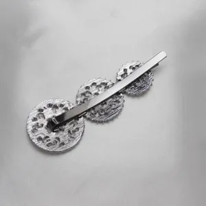 Silver filigree round hairpin detail, elegant metallic hair clip accessory for women and girls.