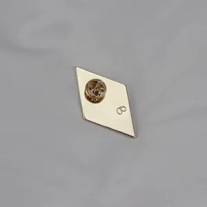 Detailed view of the diamond brooch back, showing secure pin clasp and metal hallmark.
