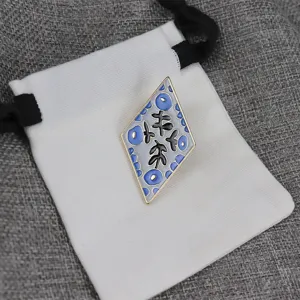 Detailed view of the diamond enamel brooch featuring a unique artistic floral pattern.