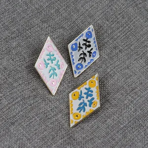 Diamond floral enamel brooch detail shot, elegant metal fashion accessory badge in multiple colors.