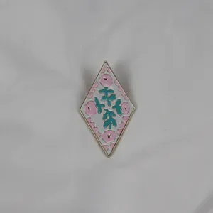 Diamond enamel brooch featuring a delicate pink and green floral pattern with gold-toned trim.