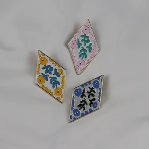 Enamel diamond brooch set with floral abstract pattern, elegant clothing accessory for daily wear.