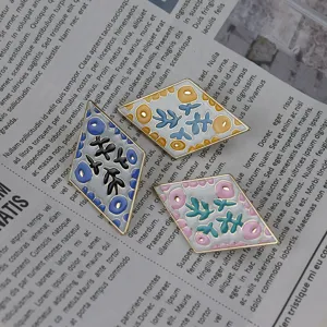Diamond enamel brooch set featuring unique floral patterns. Vintage style accessory pin.