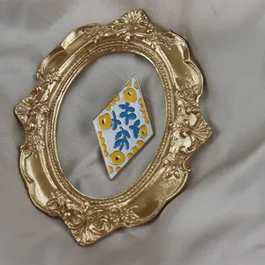 Exquisite rhombus enamel brooch featuring unique artistic floral pattern in elegant style.