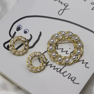 Vintage hollow chain round pearl brooch and stud earrings jewelry set details view.