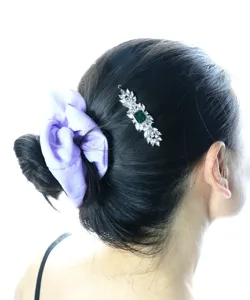 Exquisite vintage crystal hair clip with green center stone and purple fabric scrunchie detail.