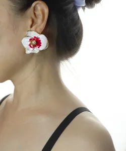 Close-up detail shot of the elegant enamel orchid flower earring worn by the model.