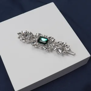 Close-up detail of vintage style green crystal rhinestone hair clip accessory elegance