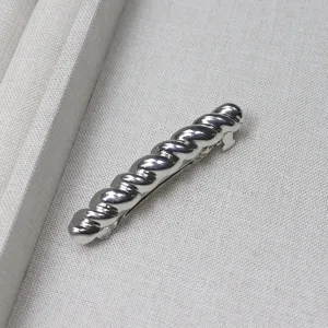 Silver twisted metal barrette detail shot, elegant small hair clip for women daily wear.