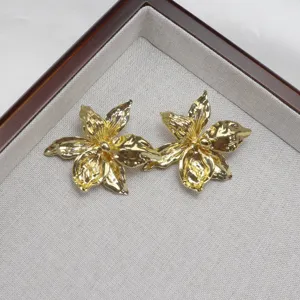 Detailed close-up of exquisite metallic gold iris flower jewelry pieces showcasing fine texture.