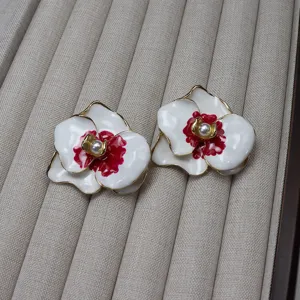 Vintage enamel orchid flower earrings with pearls and gold rim, elegant floral jewelry studs.