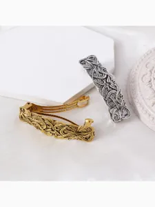 Vintage alloy Roman engraved hair clip detail showing gold and silver spring barrettes.