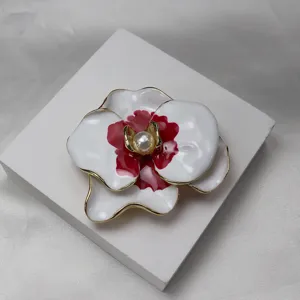 Detailed close-up of the vintage white and red enamel phalaenopsis flower brooch pendant.