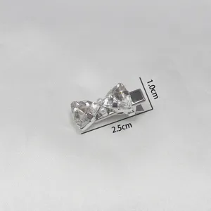 Silver bow hair clip with crystal rhinestones and pearls, compact and stylish accessory.