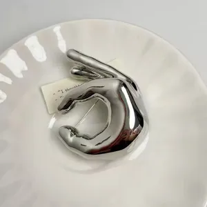 Silver metal OK hand gesture brooch, minimalist niche design for chic sweater jackets.