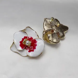 Detailed close-up of vintage enamel pearl phalaenopsis flower earrings showing front and back design.