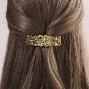 Vintage metal hair barrette with intricate engraved patterns, elegant spring clip for women.