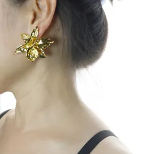 Exquisite gold metallic 3D iris flower stud earrings, elegant minimalist fashion jewelry design.